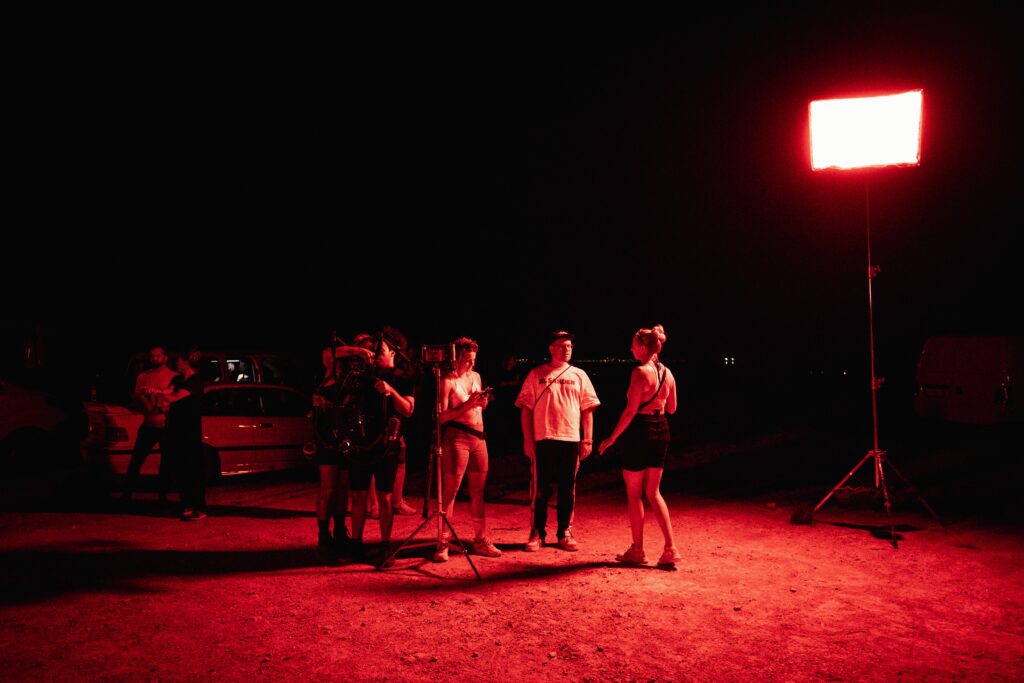 red light on group of filmmakers discussing the next shot for nico santos music video