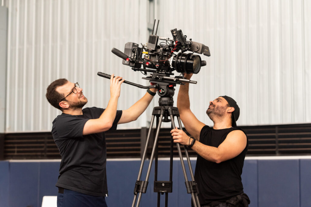 2 cameramen set the tripod for a production in mallorca