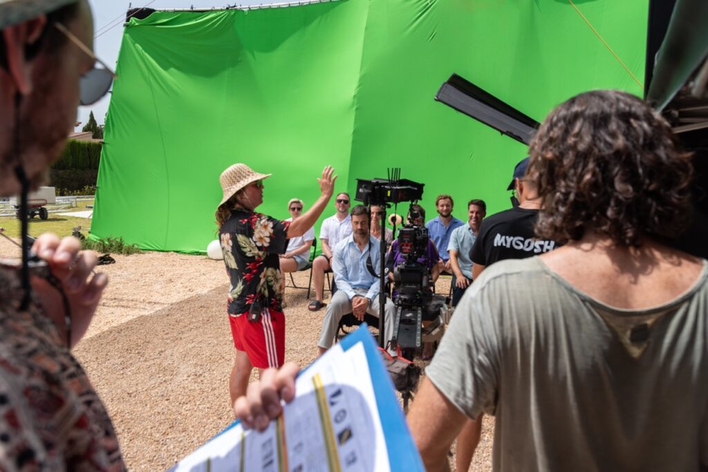 1st AD directing the extras with green screen